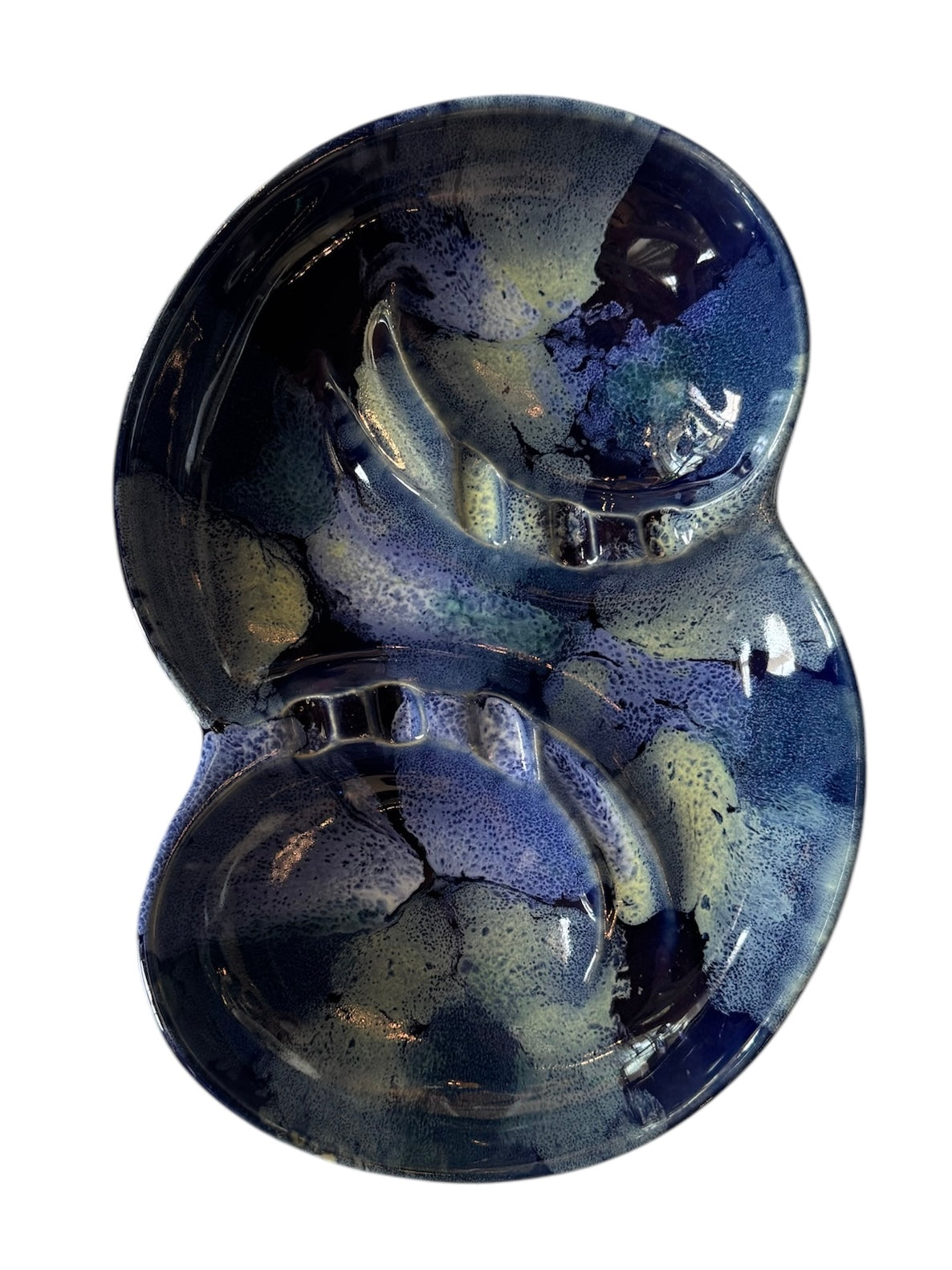 Vintage McCoy ashtray. Glazed in dark blue and marbled with lighter blues. The bottom is stamped 'McCoy USA.'"
