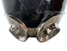 A large, decorative ceramic bowl by Dolbi Cashier in a dramatic Postmodern style. The top half is finished in a polished, piano-black glaze with an organic, wavy "butterfly" rim that dips in the center and rises at the sides. The bottom half is finished in a reflective, metallic silver chrome glaze, featuring bold, geometric-rounded feet and a structured base that appears to "hold" the black vessel. The overall shape is wide and sculptural, reminiscent of 1980s Art Deco Revival.