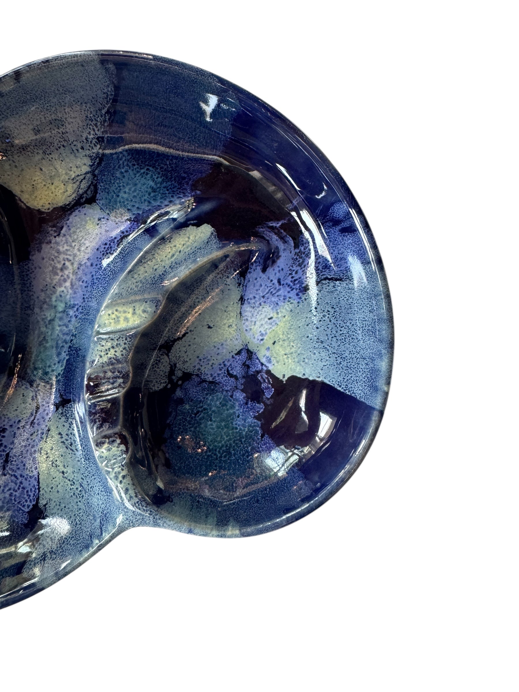 Vintage McCoy ashtray. Glazed in dark blue and marbled with lighter blues. The bottom is stamped 'McCoy USA.'"
