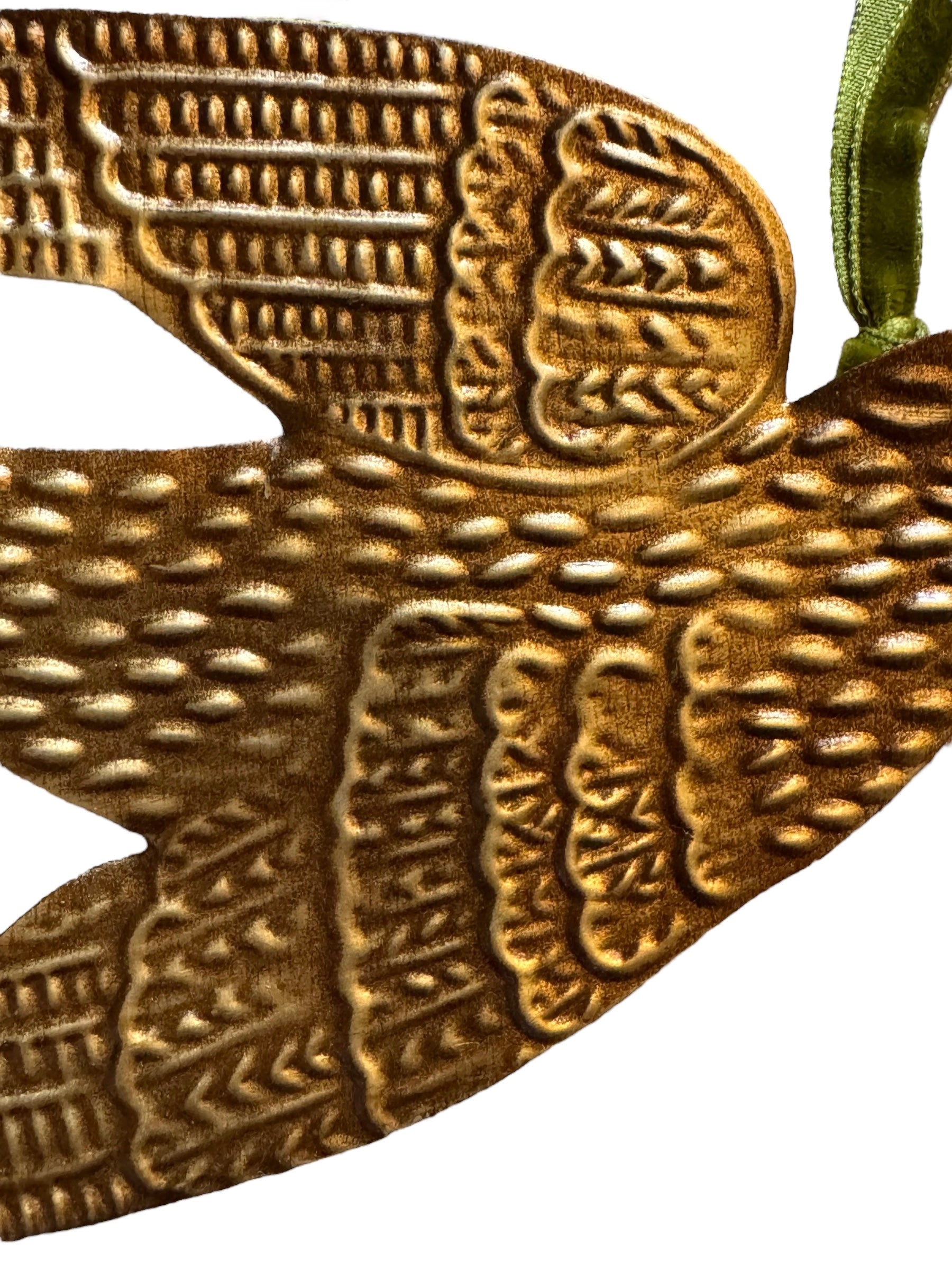 mage of a vintage-style, gilded tin bird with embossed feather detailing. A green velvet ribbon is attached. Front and back views shown.