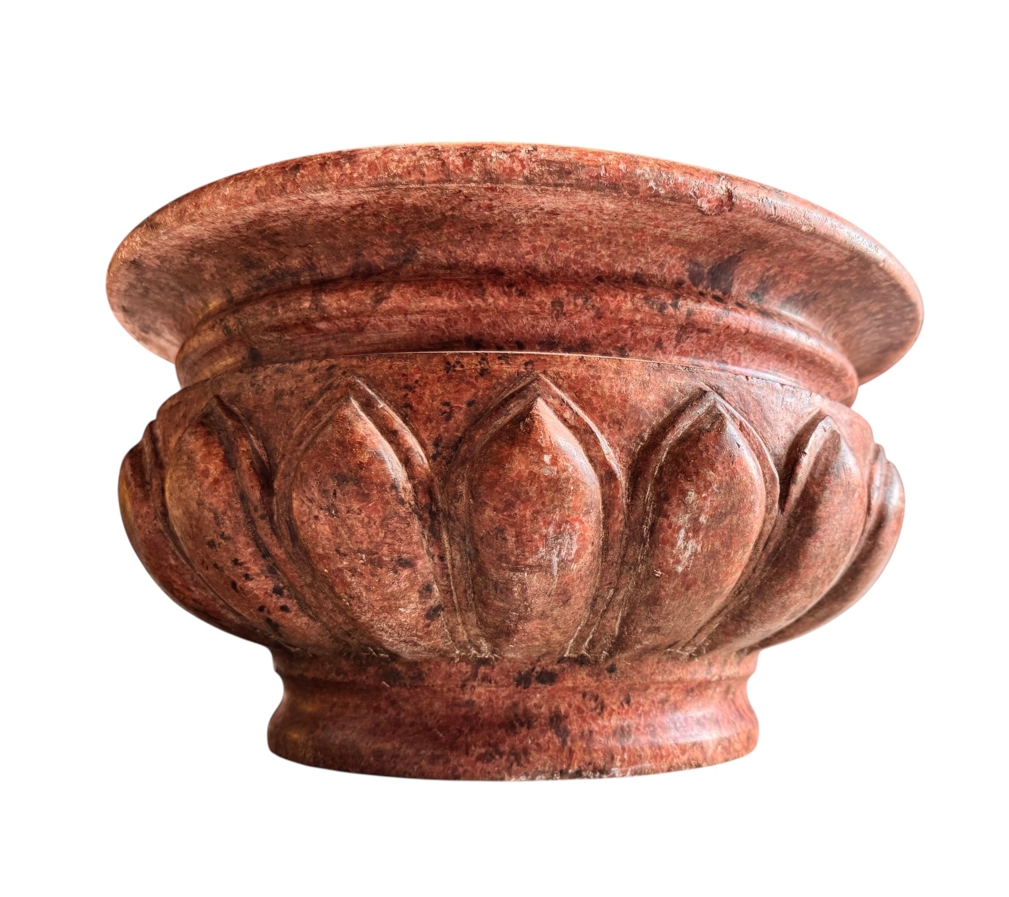 A carved pink granite planter with a leaf pattern, designed for indoor use without drainage.