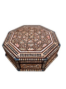 An ornate octagonal Syrian inlaid box, intricately decorated with geometric patterns made from dark wood, iridescent mother-of-pearl, vibrant abalone shell, and pale bone