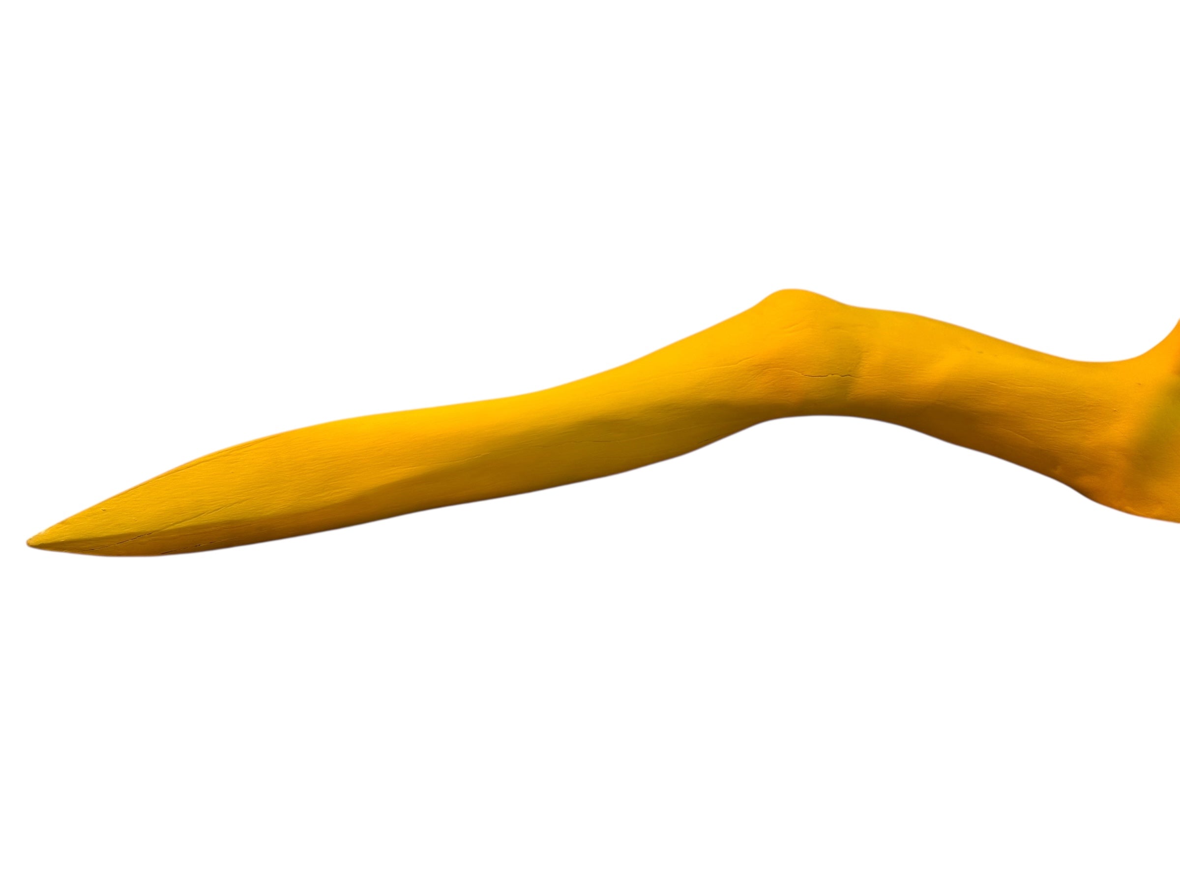 A bright yellow abstract sculpture depicting a calamari with a thick base and several thin, curving, branch-like extensions.