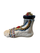Ceramic foot sculpture by Domenico Pinto featuring hand-painted details, gold accents, a sacred heart, and an angel figure with a blindfold