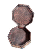 An ornate octagonal Syrian inlaid box, intricately decorated with geometric patterns made from dark wood, iridescent mother-of-pearl, vibrant abalone shell, and pale bone