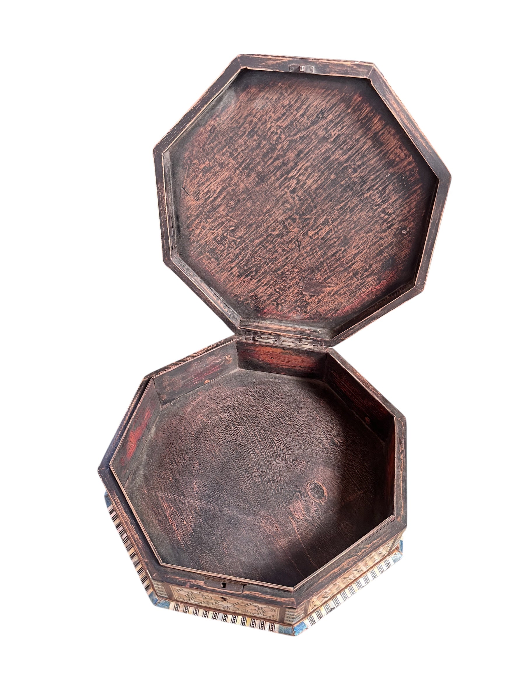 An ornate octagonal Syrian inlaid box, intricately decorated with geometric patterns made from dark wood, iridescent mother-of-pearl, vibrant abalone shell, and pale bone