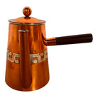 The set includes a large, rectangular, hammered copper tray with geometric openwork handles. Resting on the tray is a tall, slightly tapered copper coffee pot with a wooden handle, a matching smaller creamer pitcher with a similar wooden handle, a lidded sugar bowl, and a tiny matching metal cup or jigger. To the right off the tray sits a large, spherical copper water pitcher or jug with a wide mouth and ice lip.