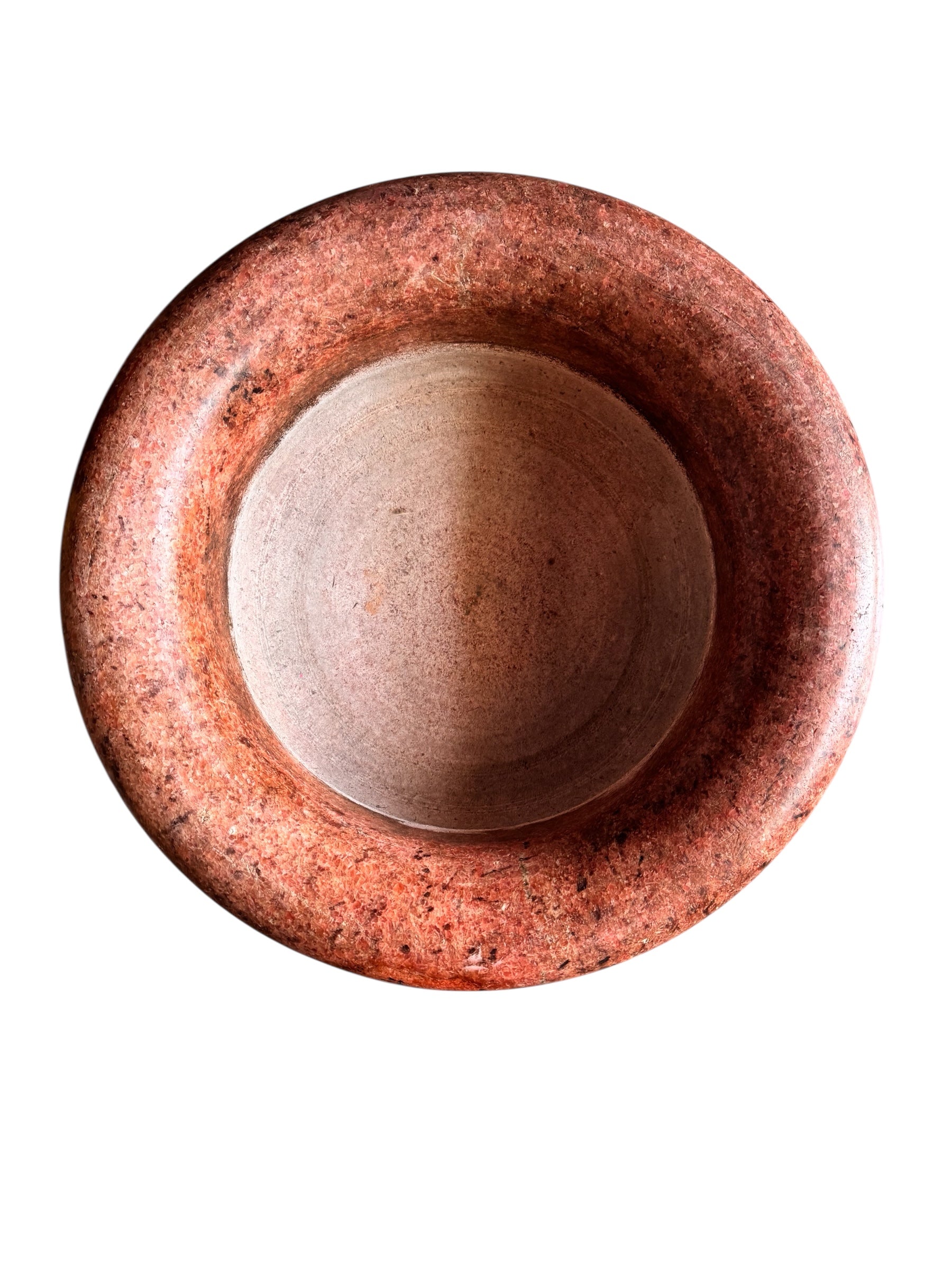 A carved pink granite planter with a leaf pattern, designed for indoor use without drainage.