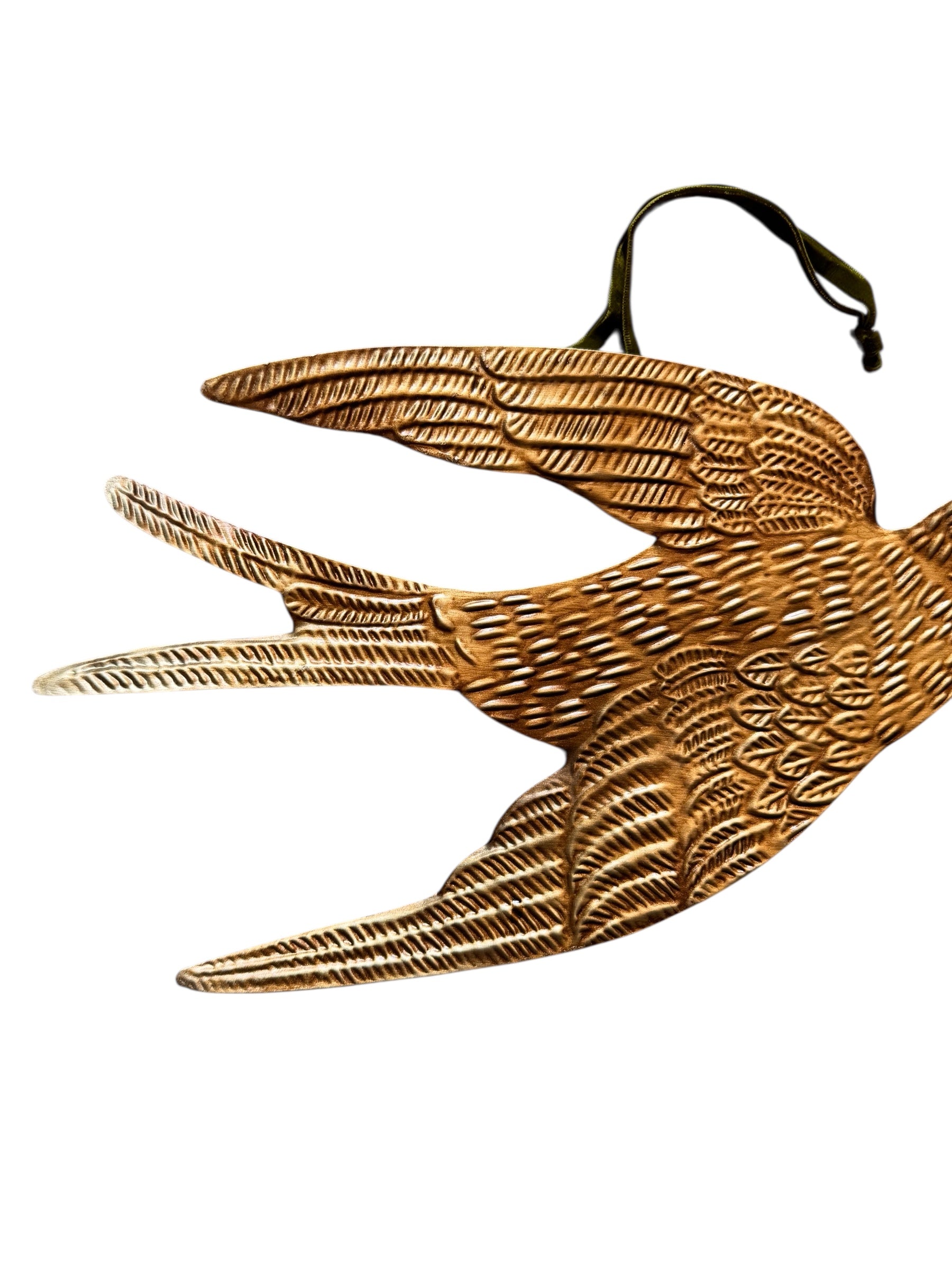 mage of a vintage-style, gilded tin bird with embossed feather detailing. A green velvet ribbon is attached. Front and back views shown.