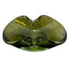 A vintage, Mid-Century Modern, peridot green art glass ashtray or catchall bowl with a curved, free-form design.