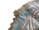 A round, cream-colored tablecloth featuring a dramatic, scalloped border shaped like six large flower petals. The border is intricately embroidered with a coastal motif including pink starfish, seashells, and teal-blue swirling waves. Gold beaded accents line the inner circular seam and the outer edges.
A long, narrow cream runner with matching scalloped, wavy edges. It is adorned with the same nautical embroidery of pink starfish and seashells scattered across the center and concentrated along the edge.