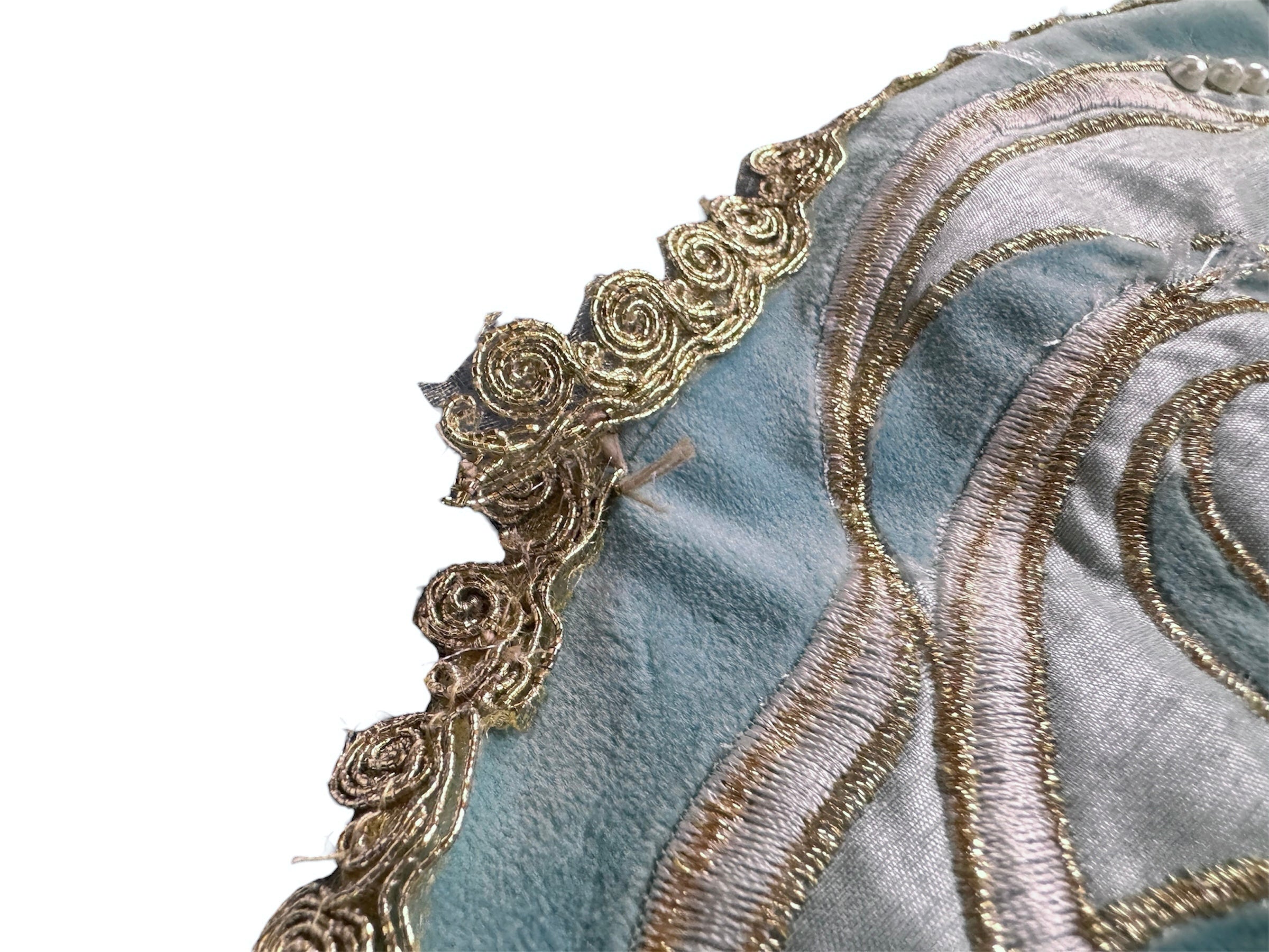 A round, cream-colored tablecloth featuring a dramatic, scalloped border shaped like six large flower petals. The border is intricately embroidered with a coastal motif including pink starfish, seashells, and teal-blue swirling waves. Gold beaded accents line the inner circular seam and the outer edges.
A long, narrow cream runner with matching scalloped, wavy edges. It is adorned with the same nautical embroidery of pink starfish and seashells scattered across the center and concentrated along the edge.