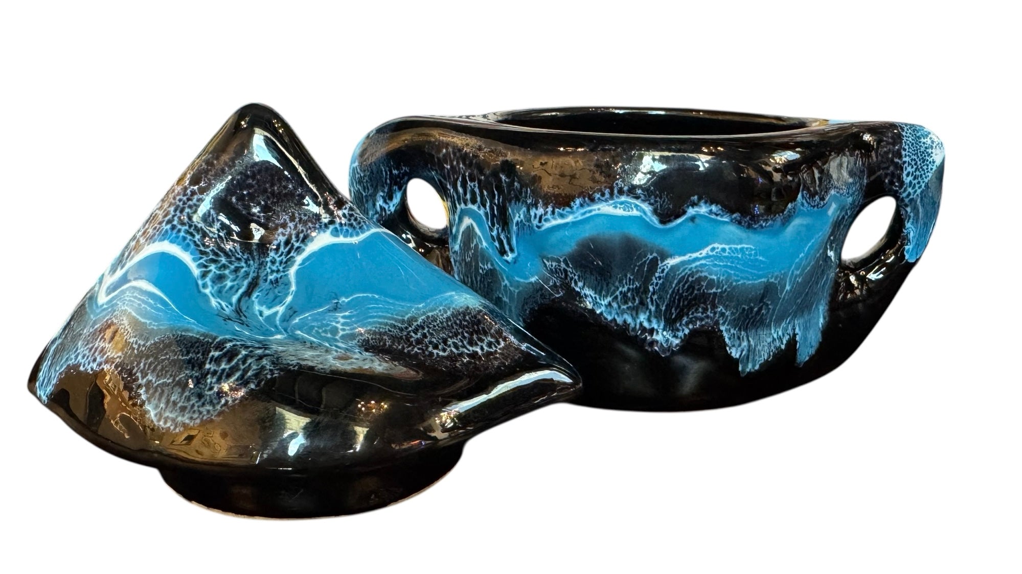 Complete mid-century ceramic tea set with teapot, sugar bowl, cups, and saucers, featuring a bold blue and black "lava drip" glaze reminiscent of Vallauris pottery.