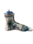 Close-up of Domenico Pinto's 'Mare Dentro' ceramic sculpture: foot, ship with gold sail, Apulian style