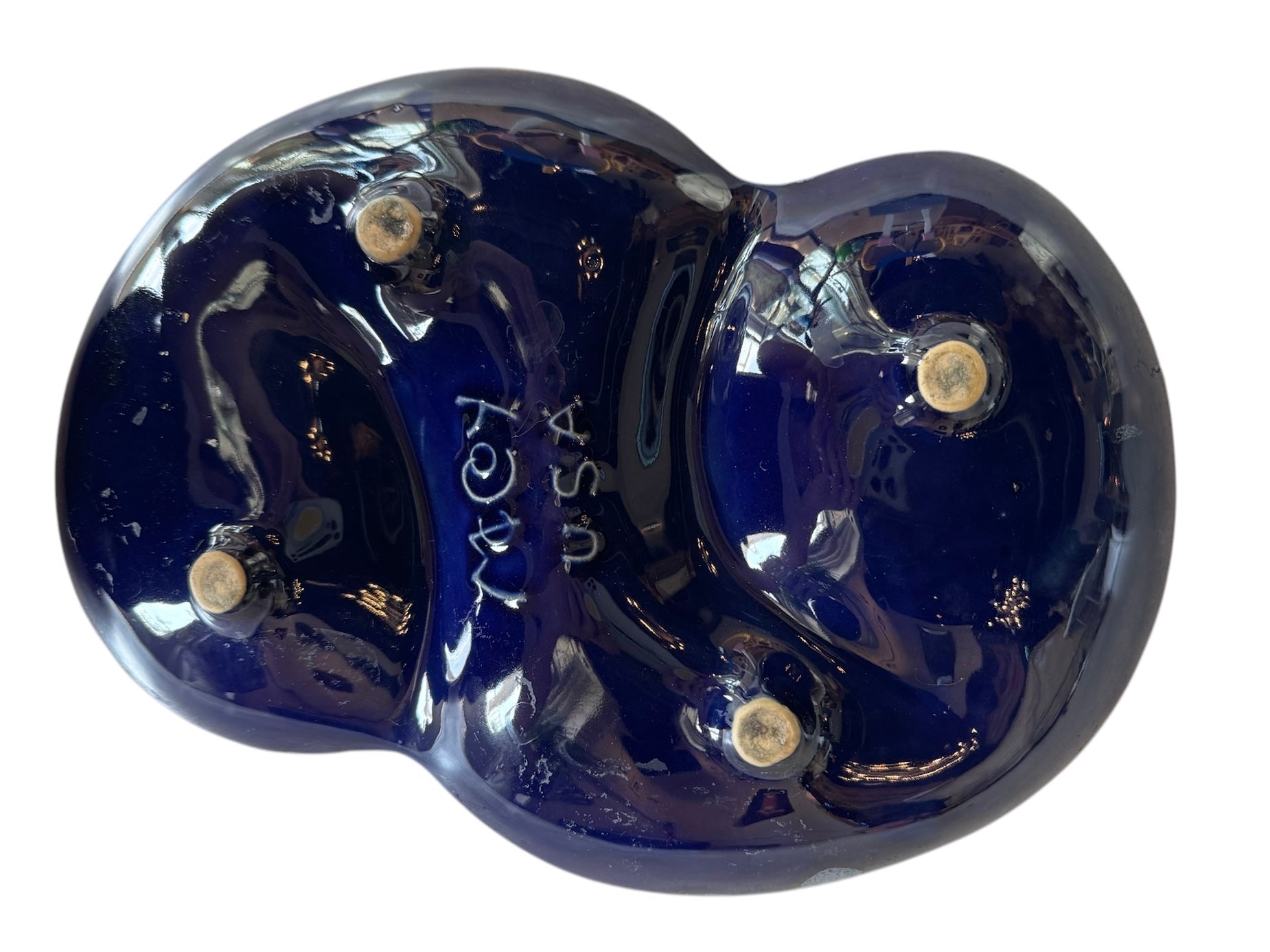 Vintage McCoy ashtray. Glazed in dark blue and marbled with lighter blues. The bottom is stamped 'McCoy USA.'"