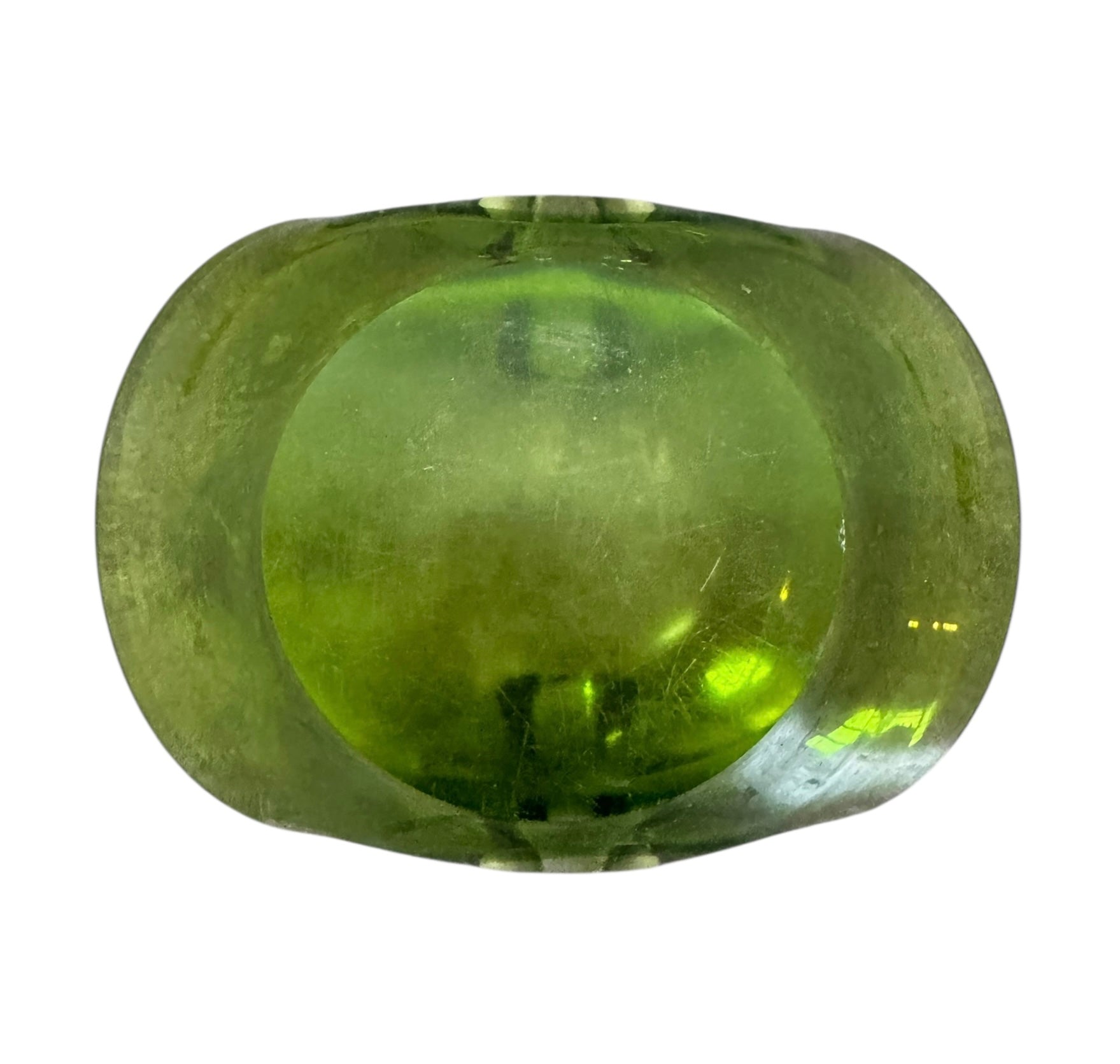 A vintage, Mid-Century Modern, peridot green art glass ashtray or catchall bowl with a curved, free-form design.