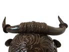 Glossy dark brown ceramic bull sculpture with intricate, hand-incised swirling patterns and a nose ring.