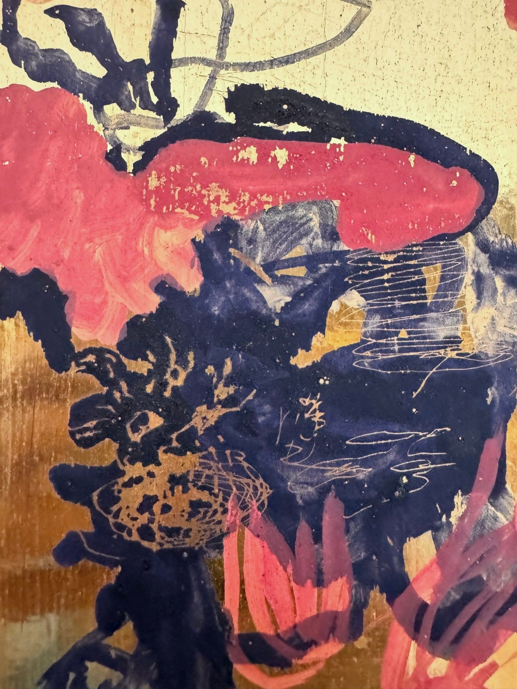 A vibrant abstract painting on a metallic gold-toned panel characterized by dense, energetic layering. The palette is dominated by saturated pinks, deep blacks, and earthy oranges.
In the upper half, horizontal strokes of orange and pink suggest a sunset or landscape, while the lower half features heavy, gestural applications of black paint that anchor the composition. Fine, white or silver linear scribbles are scratched into or layered over the pigment, adding a sense of frantic movement.