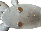 A white glazed ceramic platter in the shape of a prickly pear cactus pad with attached prickly pear fruit. The surface has raised dots representing spines