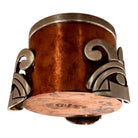 The set includes a large, rectangular, hammered copper tray with geometric openwork handles. Resting on the tray is a tall, slightly tapered copper coffee pot with a wooden handle, a matching smaller creamer pitcher with a similar wooden handle, a lidded sugar bowl, and a tiny matching metal cup or jigger. To the right off the tray sits a large, spherical copper water pitcher or jug with a wide mouth and ice lip.