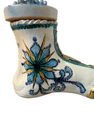 Close-up of Domenico Pinto's 'Mare Dentro' ceramic sculpture: foot, ship with gold sail, Apulian style