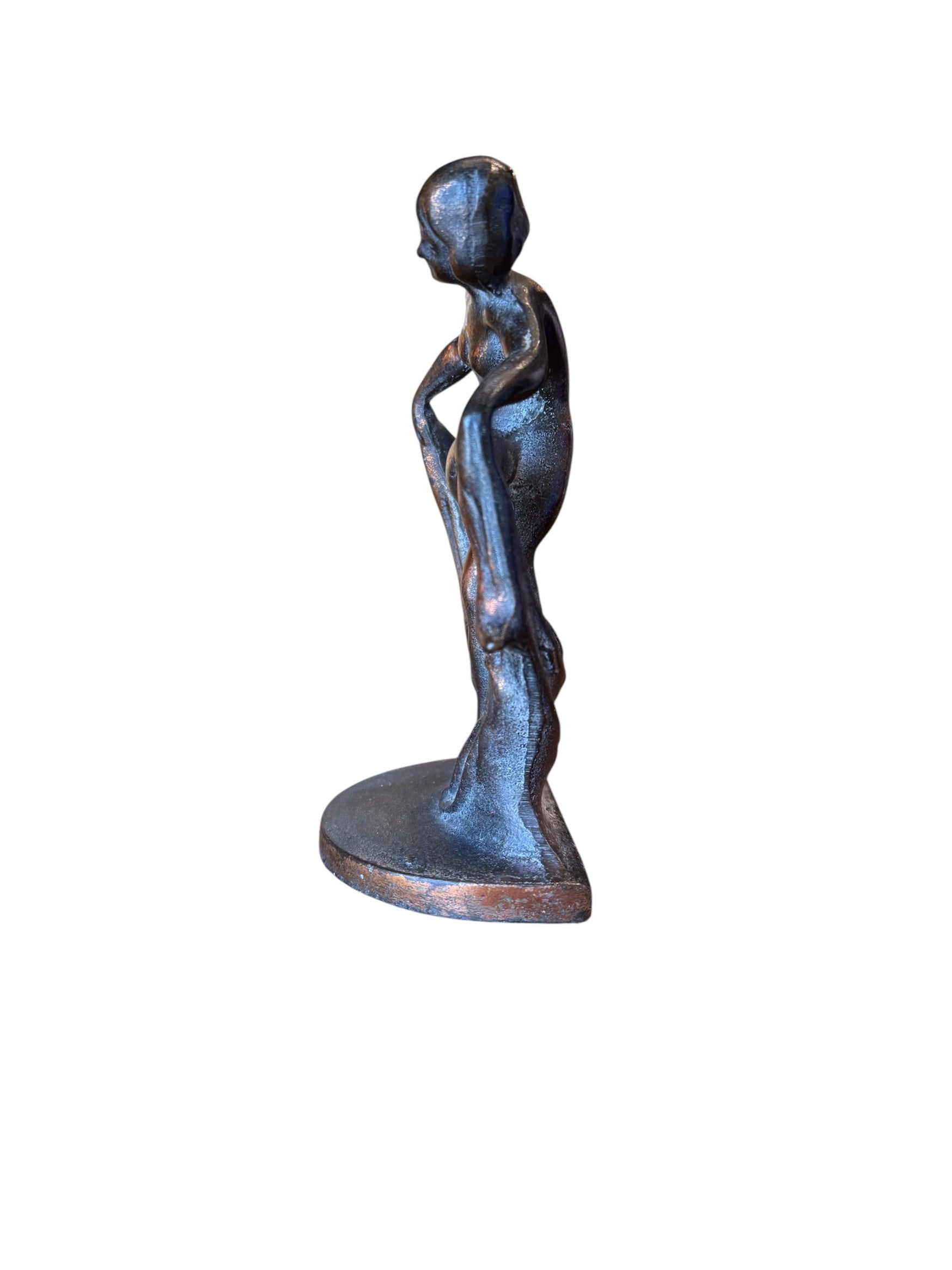 Two cast iron bookends in the Art Deco style. Each features a nude female figure leaning gracefully with one leg extended, posed atop a stylized wave or drape. The bookends have a bronze-colored finish and a vintage appearance.