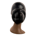 a vintage ceramic bust featuring a woman with brown skin, dark eyes, and orange lips. Her black hair is sleek and parted on the side, pulled back into a low style. She wears a small, round white earring in her right ear lobe. The bust includes her head, neck, and the upper part of her shoulders