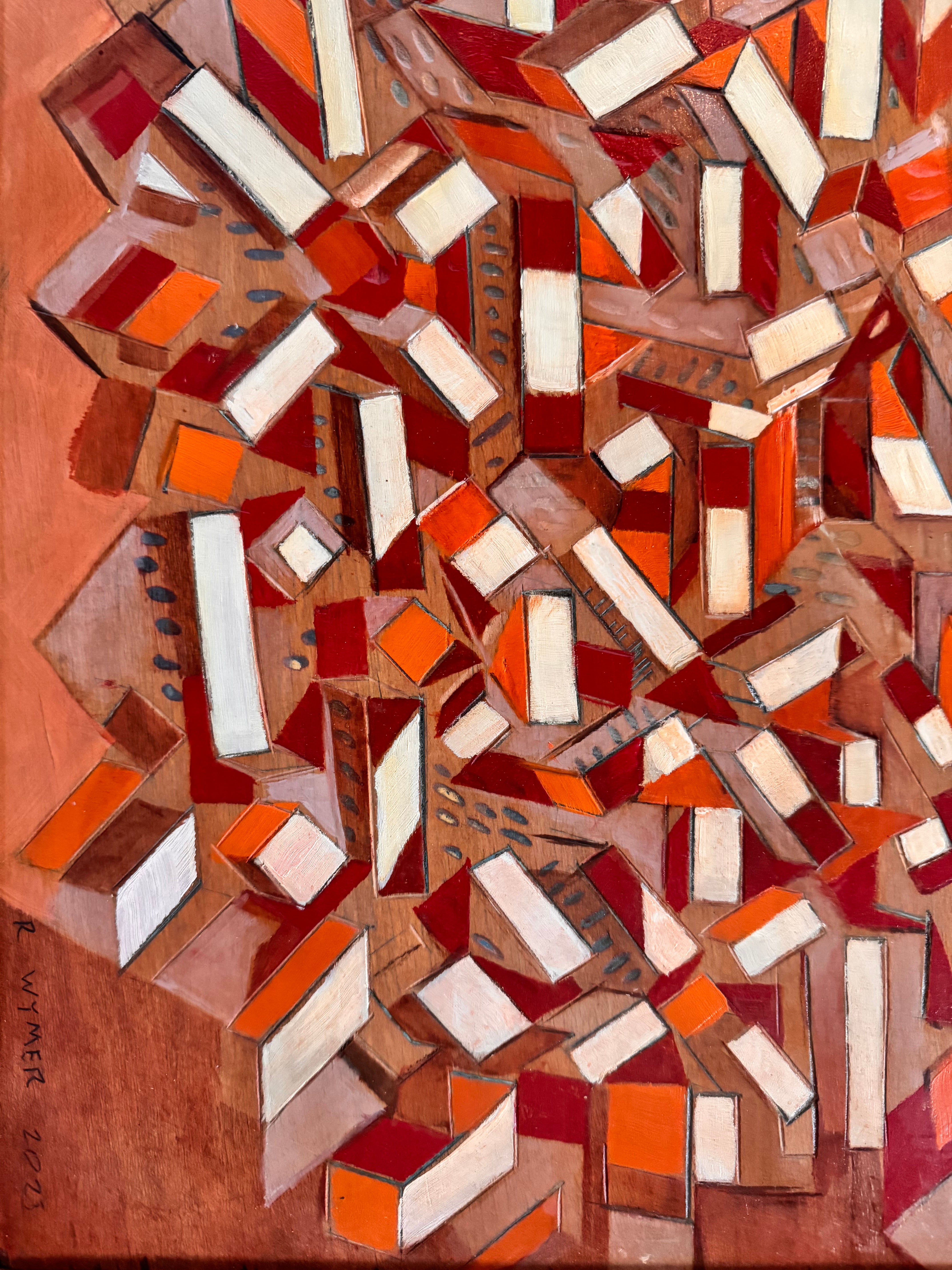 Abstract artwork with geometric shapes in red, orange, and white on a wooden background