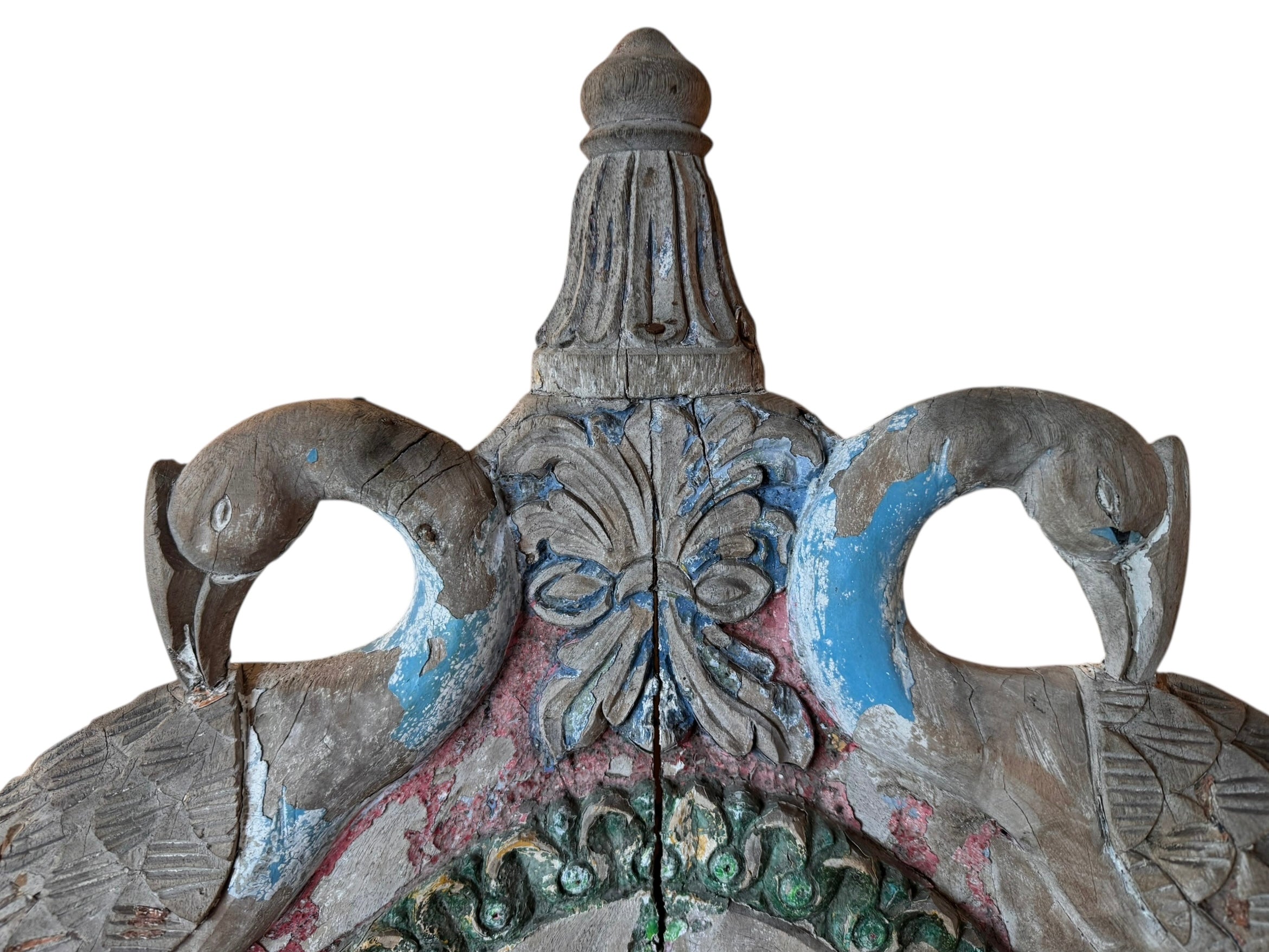 A pair of antique, heavily carved Anglo-Indian style throne chairs featuring lion figures as legs and arm supports, and peacock motifs on the backrests. The chairs have a distressed, multi-colored painted finish.