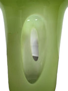 A mid-century modern, lime green cased-glass vase with a wide, flared rim and a thick, clear glass base. The exterior is a glossy chartreuse green, while the interior is lined with solid milk-white glass. The defining feature is a large, vertical oval cutout window that pierces directly through the center of the vase's body, creating an open-air negative space.
