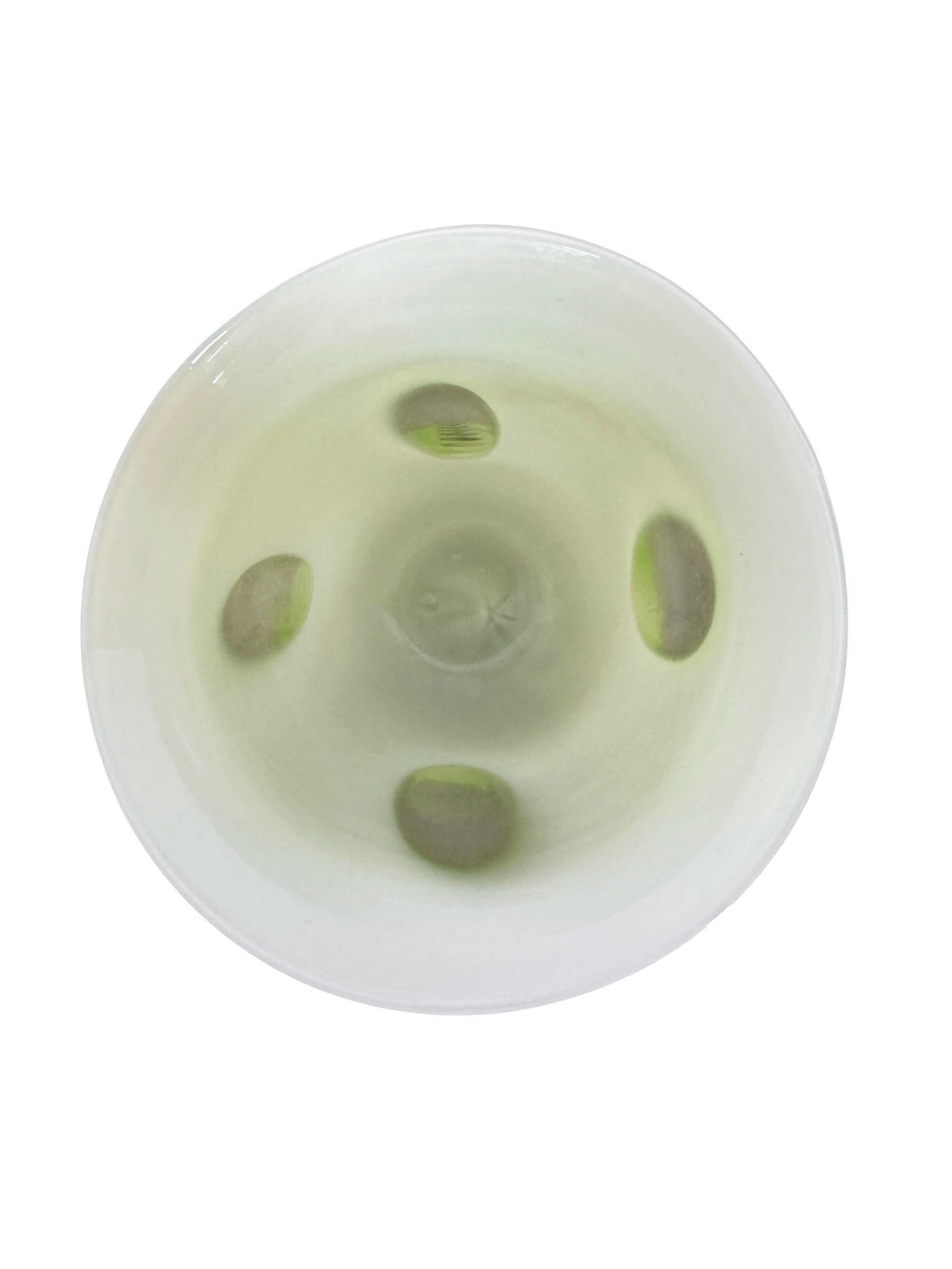 A mid-century modern, lime green cased-glass vase with a wide, flared rim and a thick, clear glass base. The exterior is a glossy chartreuse green, while the interior is lined with solid milk-white glass. The defining feature is a large, vertical oval cutout window that pierces directly through the center of the vase's body, creating an open-air negative space.