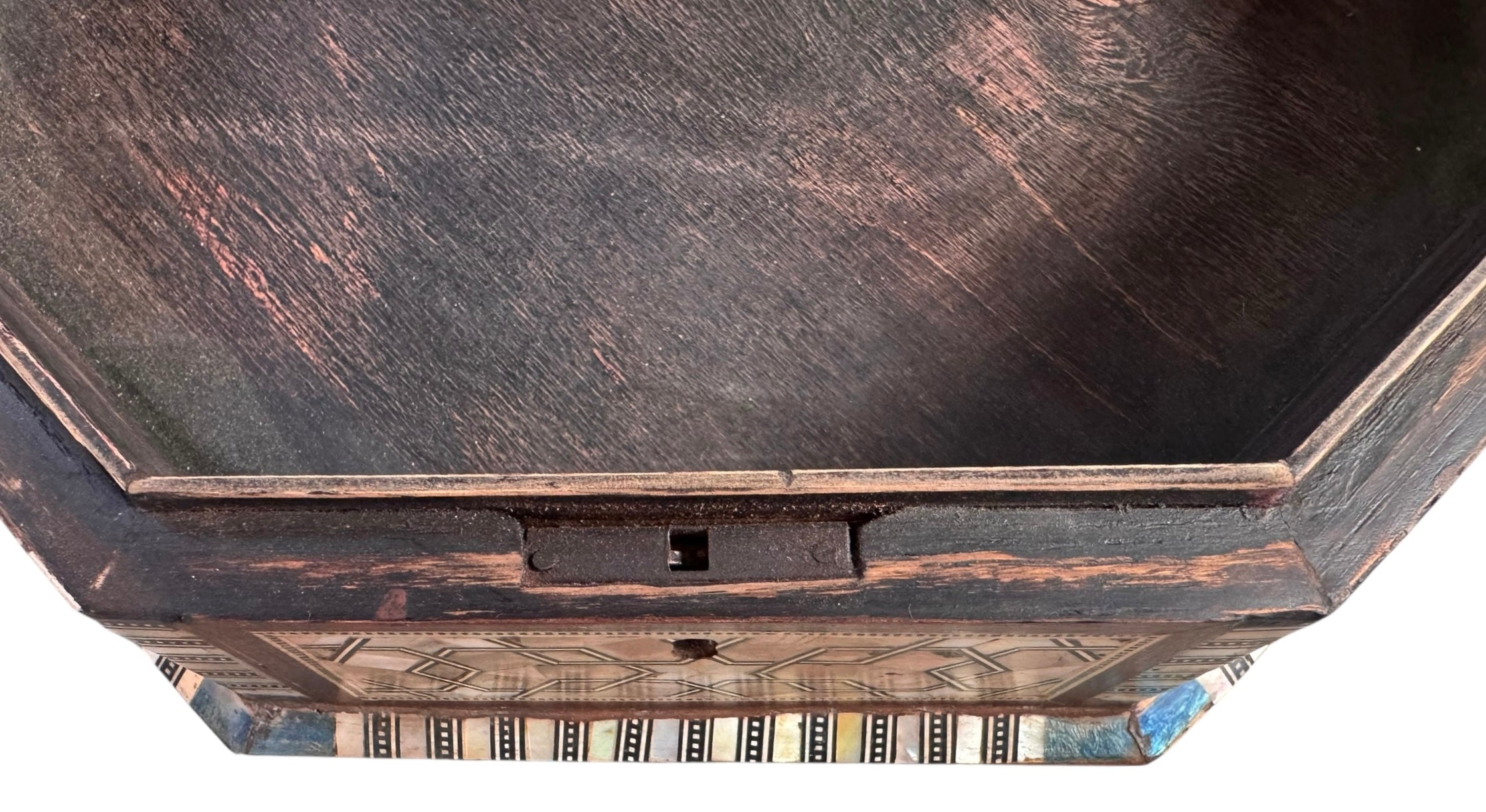 An ornate octagonal Syrian inlaid box, intricately decorated with geometric patterns made from dark wood, iridescent mother-of-pearl, vibrant abalone shell, and pale bone