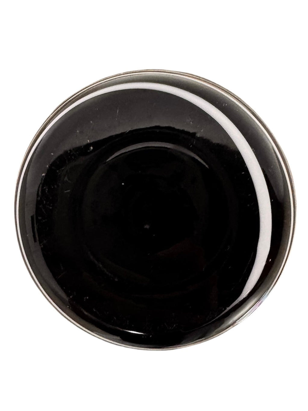 A sleek, hand-blown Polish art glass vase featuring a tall, slender neck that flares into a rounded, bulbous body. The vase is made of opaque black glass decorated with a continuous white spiral ribbon that winds around the entire piece from base to rim. The high-gloss, reflective surface creates sharp highlights, emphasizing its smooth, sculptural silhouette against a plain white background.
