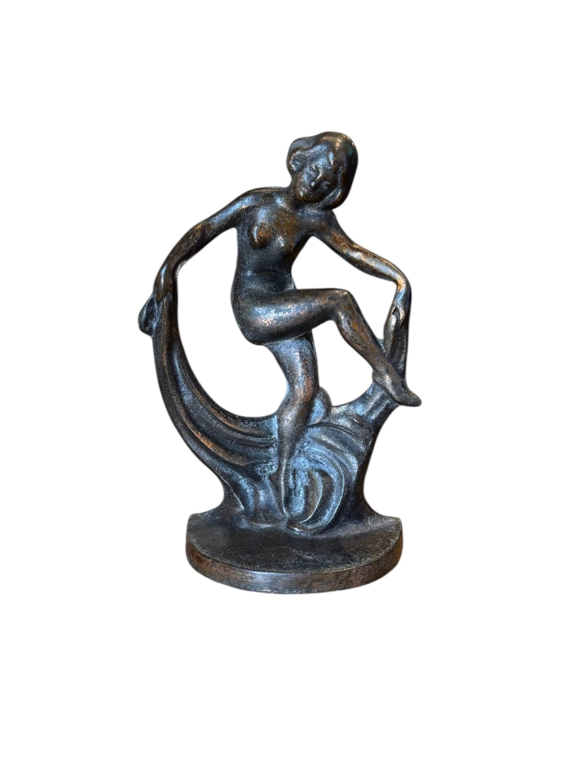 Two cast iron bookends in the Art Deco style. Each features a nude female figure leaning gracefully with one leg extended, posed atop a stylized wave or drape. The bookends have a bronze-colored finish and a vintage appearance.