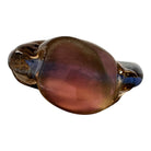 An asymmetrical Murano art glass sculpture with a heavy, biomorphic form. The piece is composed of thick, translucent smoky-amber glass with abstract, fluid bands of deep blue and dark brown swirling throughout the upper rim and sides. A dense pattern of tiny, controlled air bubbles is suspended inside the glass, concentrating heavily near the thick, solid amber base.