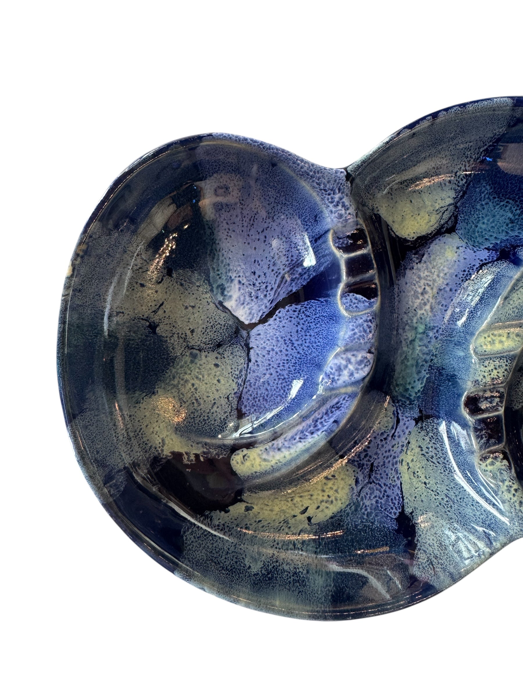 Vintage McCoy ashtray. Glazed in dark blue and marbled with lighter blues. The bottom is stamped 'McCoy USA.'"