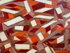 Abstract art piece with geometric shapes in red, orange, and beige.