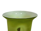 A mid-century modern, lime green cased-glass vase with a wide, flared rim and a thick, clear glass base. The exterior is a glossy chartreuse green, while the interior is lined with solid milk-white glass. The defining feature is a large, vertical oval cutout window that pierces directly through the center of the vase's body, creating an open-air negative space.