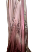 A tall, Mid-Century Modern sculptural table lamp featuring a hand-blown art glass base. The base is crafted in the Sommerso style, with a deep amethyst purple core encased in a thick, clear crystal outer layer that twists upward in an organic, fluid motion. The lamp is topped with a white, knife-pleated empire shade and a clear glass ball finial. The overall design is elegant and slender, emphasizing the contrast between the saturated purple glass and the transparent, light-refracting crystal.