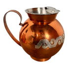 The set includes a large, rectangular, hammered copper tray with geometric openwork handles. Resting on the tray is a tall, slightly tapered copper coffee pot with a wooden handle, a matching smaller creamer pitcher with a similar wooden handle, a lidded sugar bowl, and a tiny matching metal cup or jigger. To the right off the tray sits a large, spherical copper water pitcher or jug with a wide mouth and ice lip.