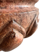 A carved pink granite planter with a leaf pattern, designed for indoor use without drainage.
