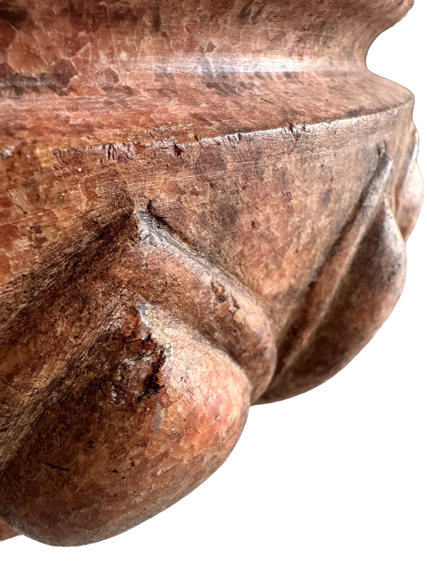 A carved pink granite planter with a leaf pattern, designed for indoor use without drainage.