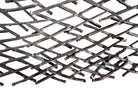 A round metal wall sculpture by Michael Aram, viewed from the front against a stark white background. The piece is composed of a dense, intricate lattice of fine, dark metal wire or twigs woven together to create a textured, web-like pattern. The structure curves inward like a funnel or a vortex, sloping down toward a clean, circular opening in the exact center, creating a strong sense of depth and dimensionality.