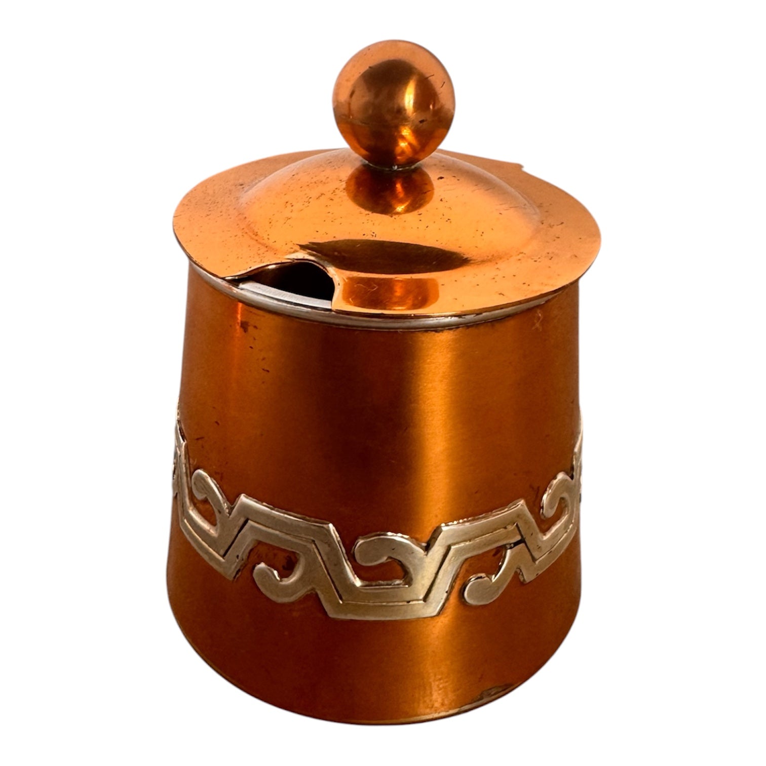 The set includes a large, rectangular, hammered copper tray with geometric openwork handles. Resting on the tray is a tall, slightly tapered copper coffee pot with a wooden handle, a matching smaller creamer pitcher with a similar wooden handle, a lidded sugar bowl, and a tiny matching metal cup or jigger. To the right off the tray sits a large, spherical copper water pitcher or jug with a wide mouth and ice lip.