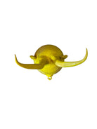 Yellow ceramic sculpture titled 'The Ram Oracle' by Enza Fasano, featuring a round body with intricate, hand-incised patterns and long, stylized ram-like horns
