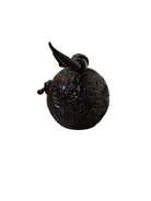 Glossy dark brown ceramic bull sculpture with intricate, hand-incised swirling patterns and a nose ring.