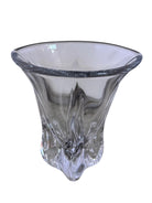 A clear crystal vase with a flared opening and a twisted, sculptural base.
The provided image is of a vintage Vannes Le Châtel crystal vase, which is a piece of French art glass