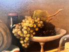 Oil painting, 'Still Life with Fruit and Cheese' by Michel Rivol, 1887. Features grapes, melons, cheese under a glass dome, and a bottle on a tablecloth against a dark background