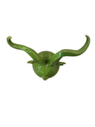 Glossy green ceramic pig sculpture with exaggerated, upward-curving horns and a snout.