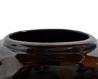A round, glossy black vase with a small opening.
The vase has a spherical or gourd-like shape and a highly reflective, black glazed finish.